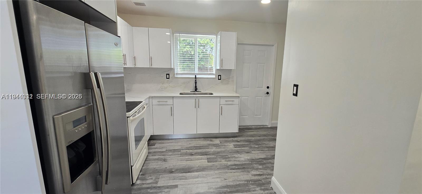 9805 Marlin Road Cutler Bay, FL 33157 - Photo 2 of 4 a kitchen with stainless steel appliances a refrigerator sink and cabinets