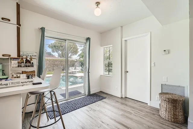 a view of a dining room with furniture window and wooden floor