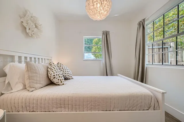 a bedroom with a large bed and a window