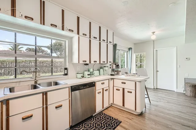 a kitchen with a sink stove and cabinets