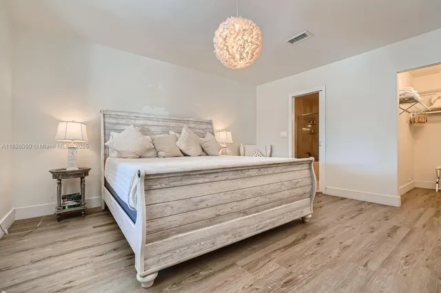 a bed room with a bed and a chandelier