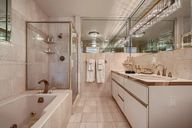 a bathroom with a tub sink and mirror