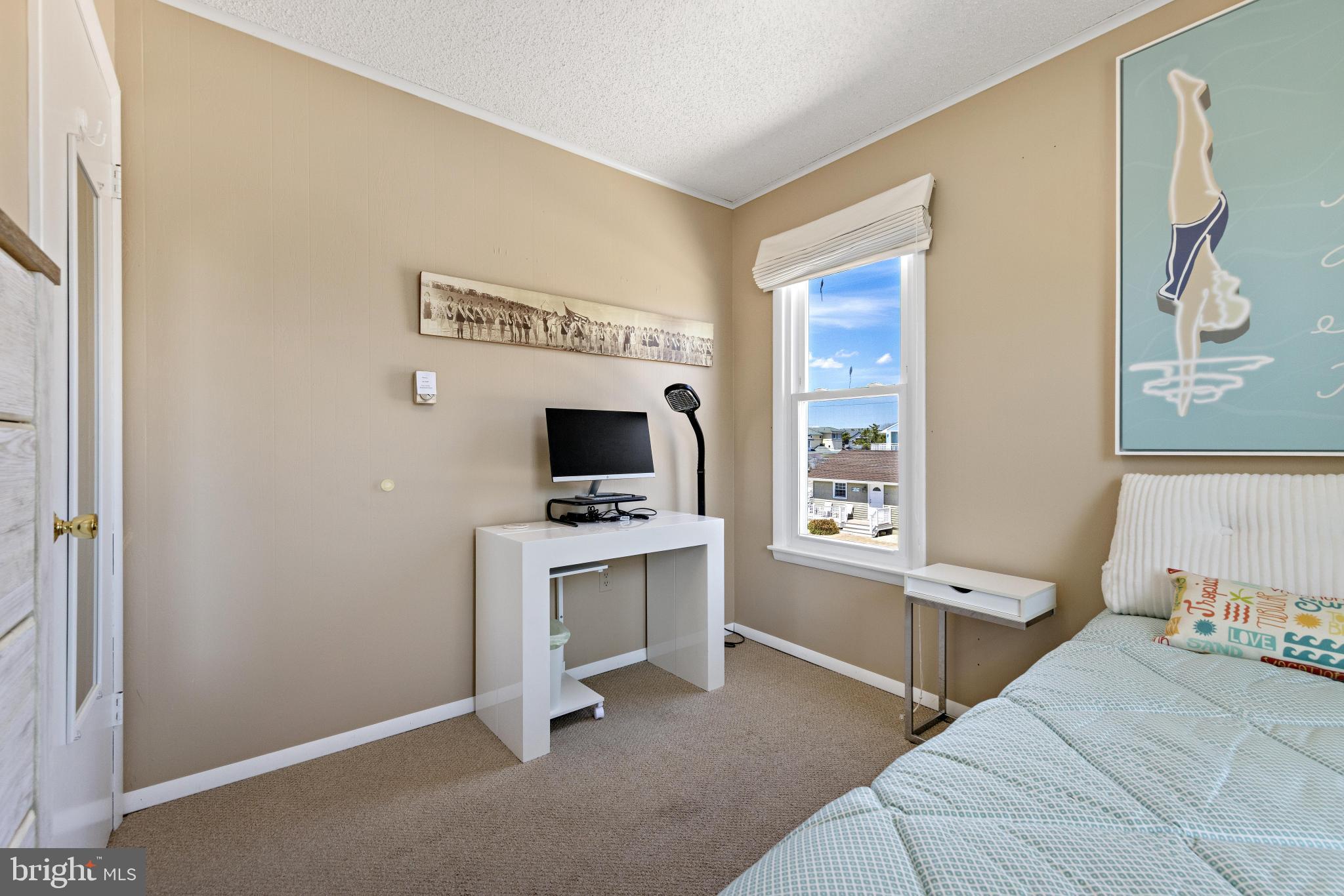 24 Joan Road Long Beach Township, NJ 08008 - Photo 17 of 55 a bedroom with a bed and a flat tv screen on the dresser