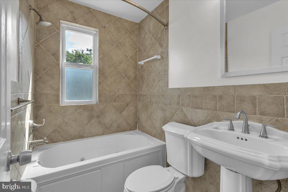 1193 46th Place Southeast Washington, DC 20019 - Photo 13 of 17 a bathroom with a sink toilet and bathtub