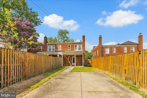 a front view of a house with a wooden fence