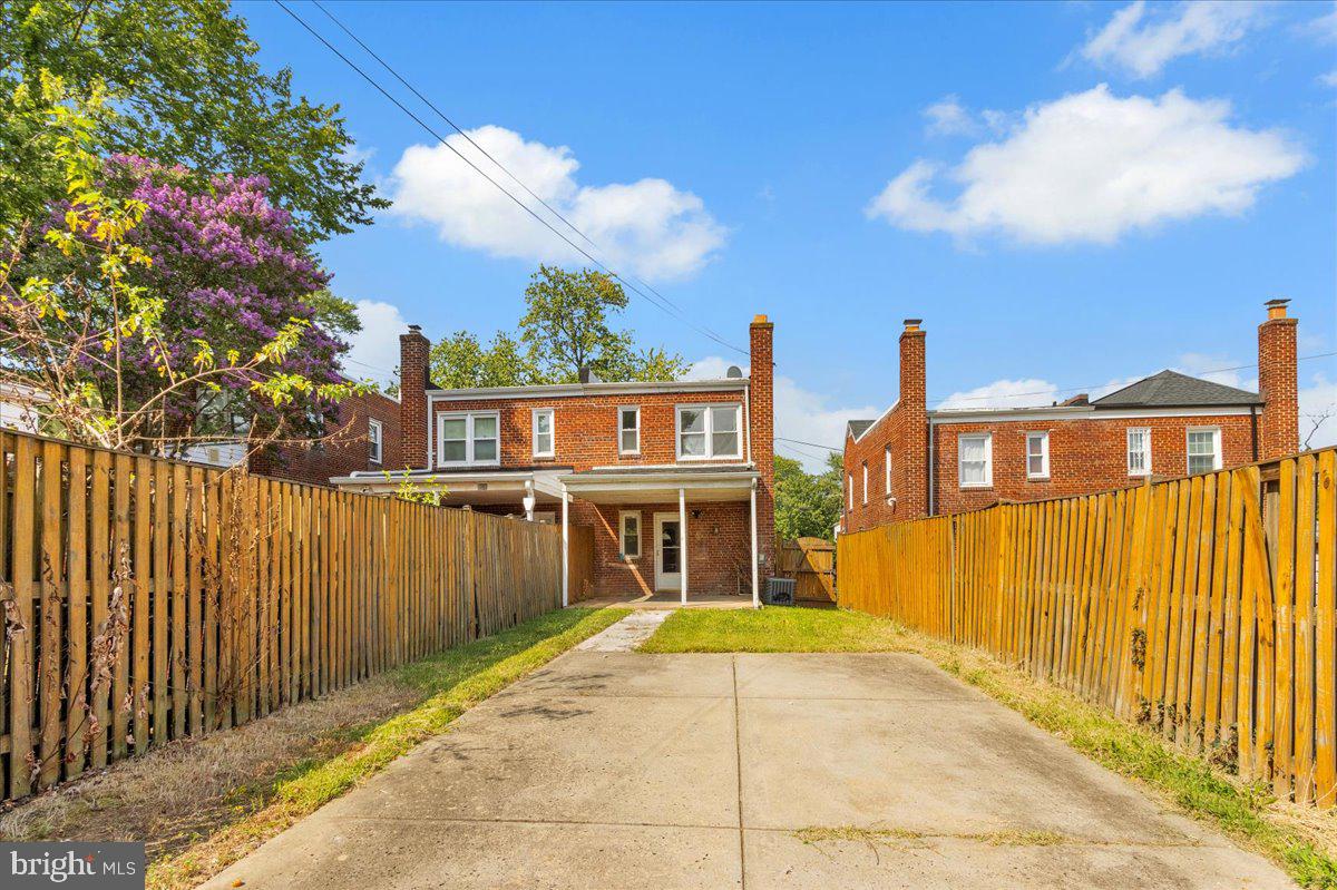 1193 46th Place Southeast Washington, DC 20019 - Photo 16 of 17 a front view of a house with a wooden fence