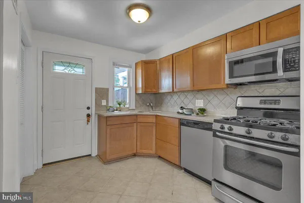 a kitchen with stainless steel appliances granite countertop a stove and a sink