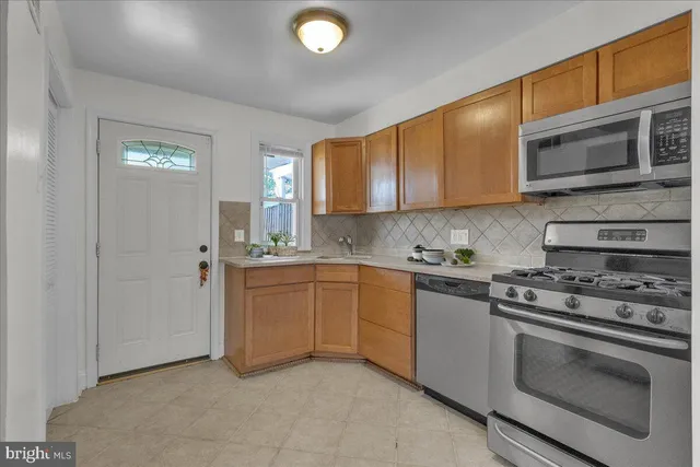 a kitchen with stainless steel appliances granite countertop a stove and a sink