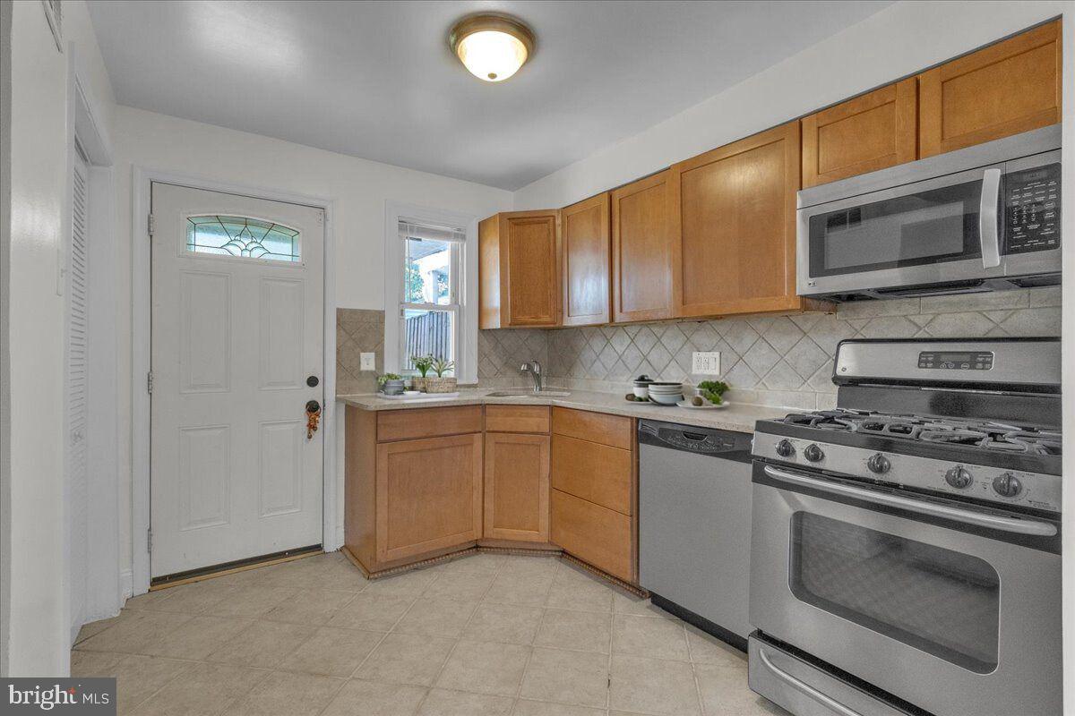1193 46th Place Southeast Washington, DC 20019 - Photo 2 of 17 a kitchen with stainless steel appliances granite countertop a stove and a sink