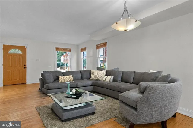 a living room with furniture and a chandelier