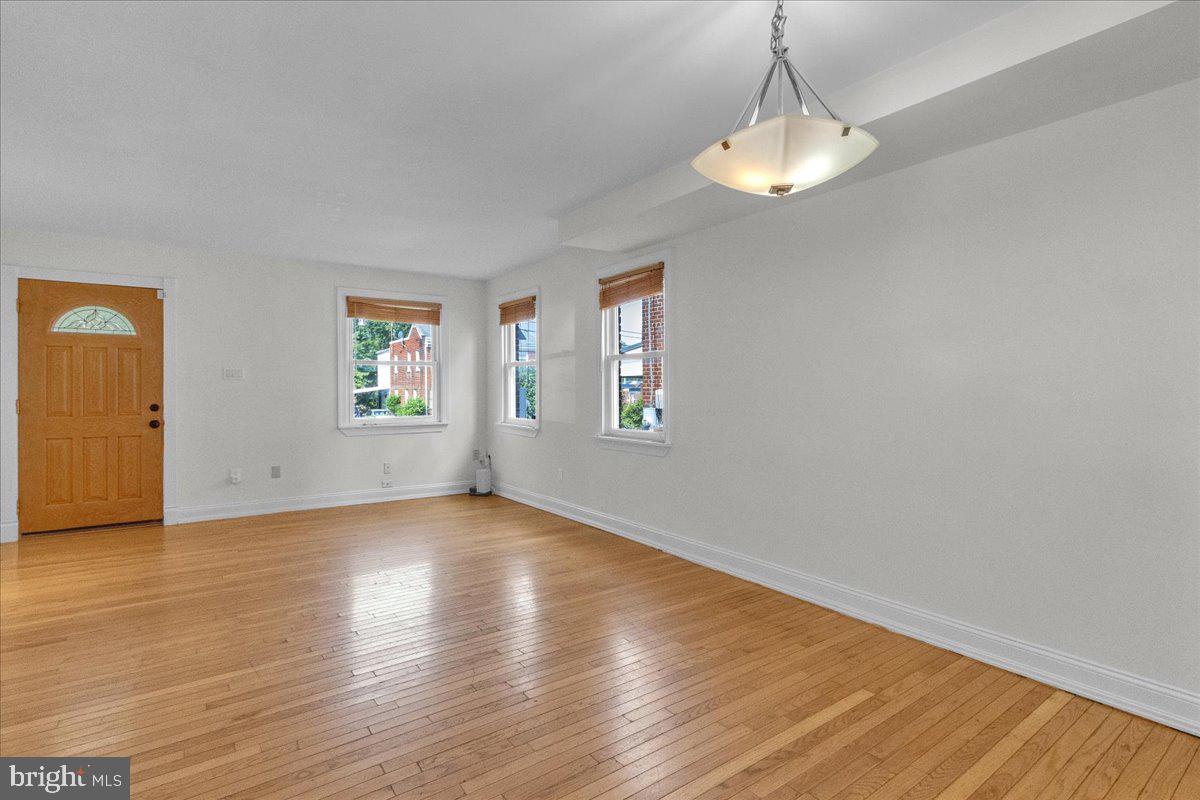 1193 46th Place Southeast Washington, DC 20019 - Photo 6 of 17 a view of an empty room with window and wooden floor