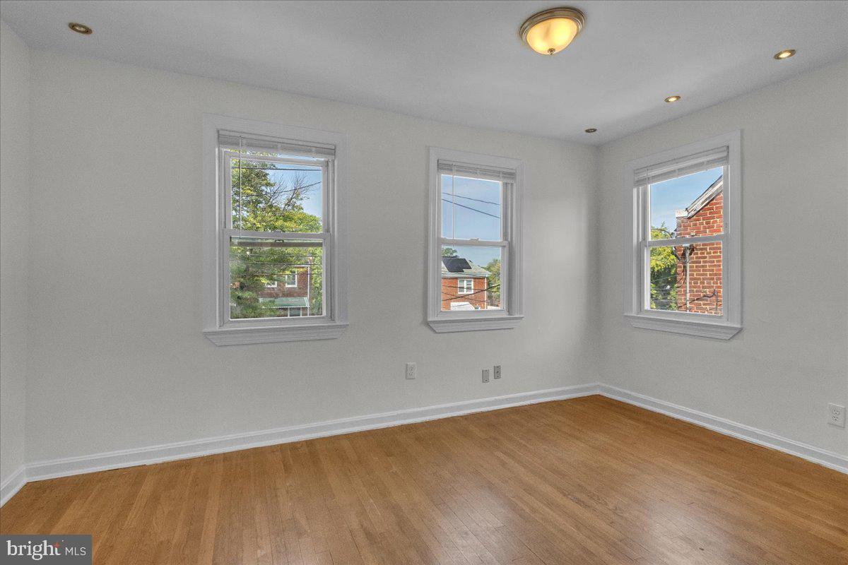 1193 46th Place Southeast Washington, DC 20019 - Photo 9 of 17 a view of empty room with window and wooden floor