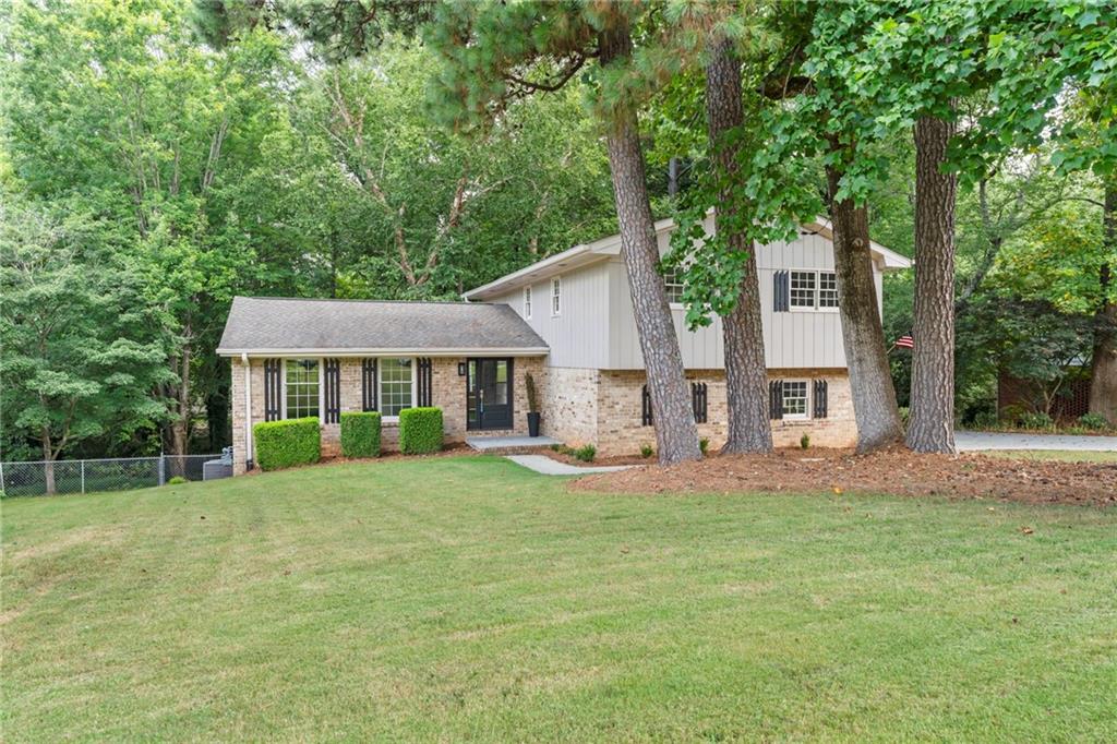 3937 Locklear Way Northwest Atlanta, GA 30360 - Photo 1 of 1 a view of a house with a yard and large tree