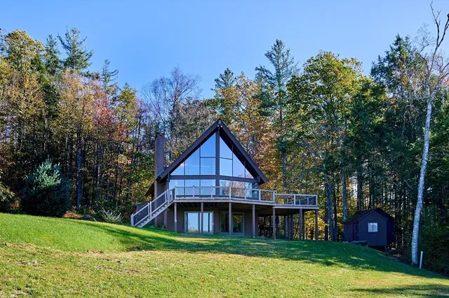 a view of a house with a yard and potted plants
