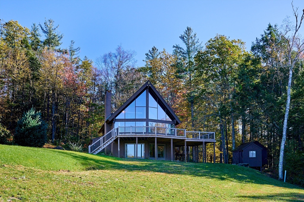 a view of a house with a yard and potted plants