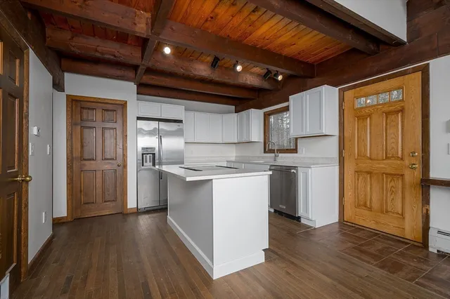 a bathroom with a granite countertop sink toilet and a mirror