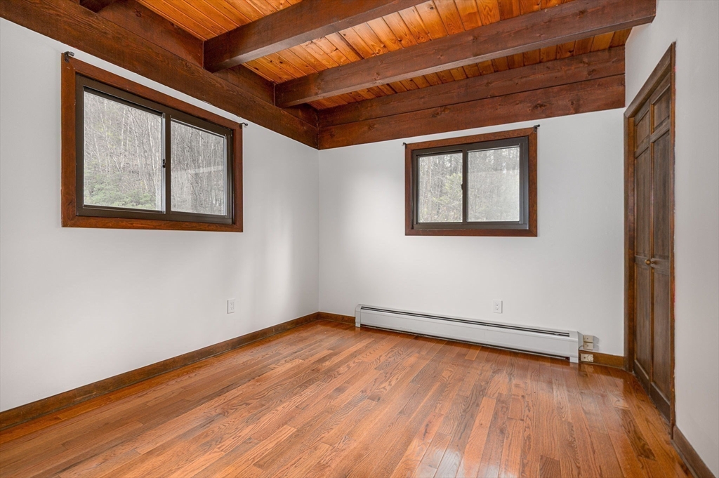 49 E Road Hawley, MA 01339 - Photo 15 of 42 a view of an empty room with wooden floor and a window