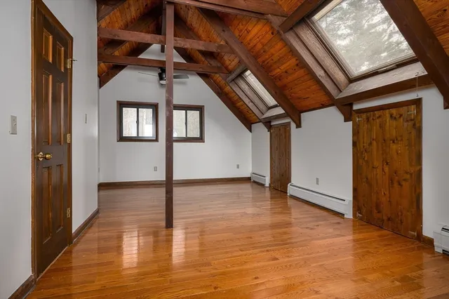 a bathroom with a granite countertop toilet sink and mirror