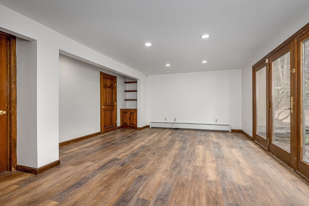 49 E Road Hawley, MA 01339 - Photo 21 of 42 an empty room with wooden floor and windows