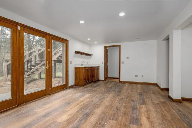 a view of a roof deck with a bench and trees