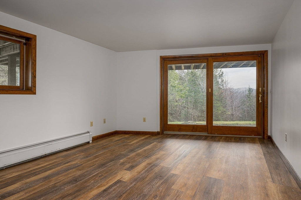 49 E Road Hawley, MA 01339 - Photo 25 of 42 a view of an empty room with wooden floor and a window
