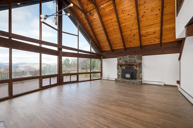 a room with wooden floors and fireplace