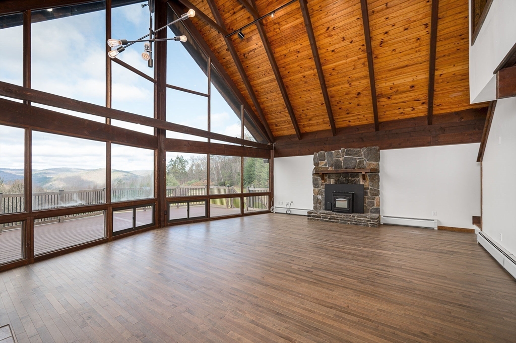 49 E Road Hawley, MA 01339 - Photo 6 of 42 a view of an empty room with wooden floor and a window