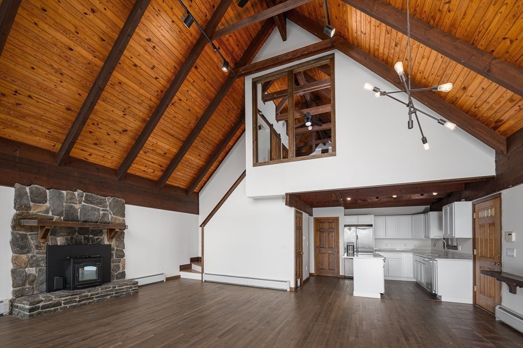 49 E Road Hawley, MA 01339 - Photo 10 of 42 a room with wooden floors and fireplace