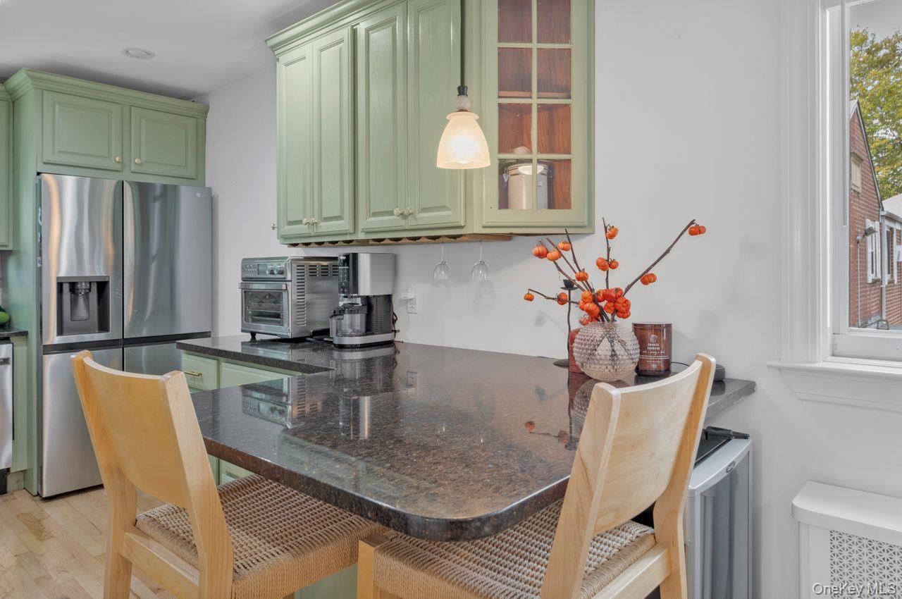 73-20 263rd Street, Unit G Queens, NY 11004 - Photo 11 of 24 a dining room with furniture and a window