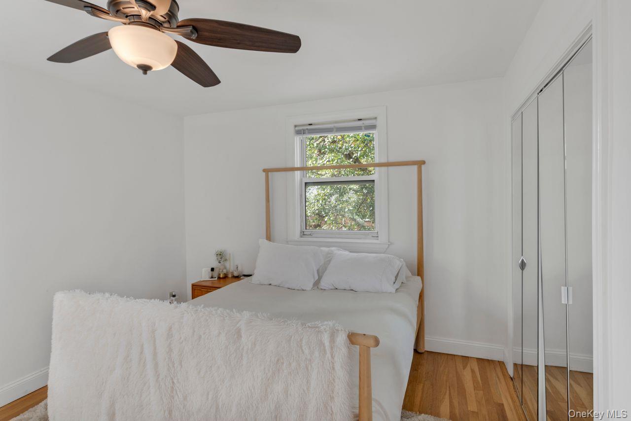 73-20 263rd Street, Unit G Queens, NY 11004 - Photo 13 of 24 a bedroom with a bed and a window