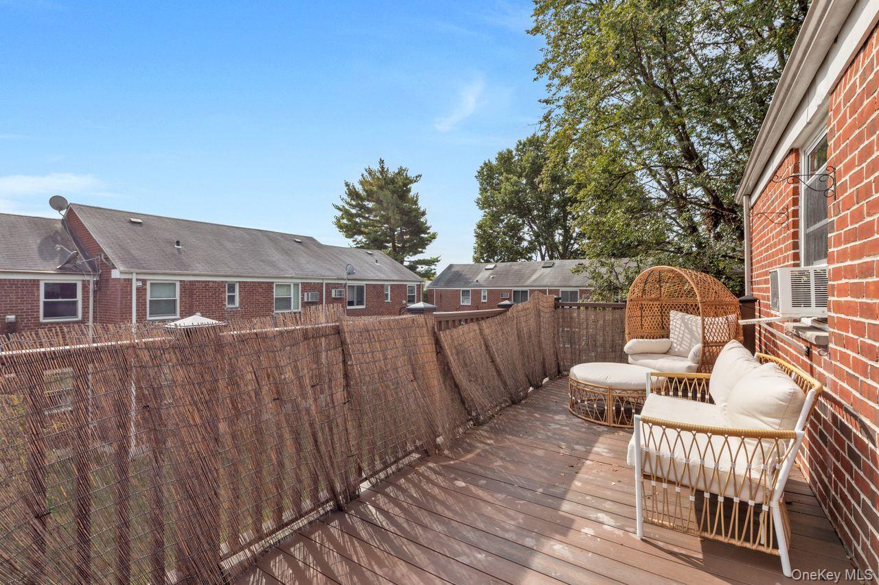 73-20 263rd Street, Unit G Queens, NY 11004 - Photo 18 of 24 a view of a chairs and table on the wooden floor