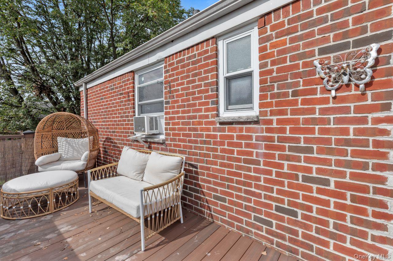 73-20 263rd Street, Unit G Queens, NY 11004 - Photo 19 of 24 a view of a chair and table in the balcony