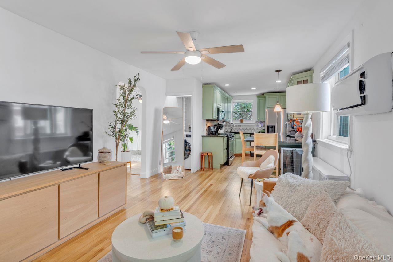 73-20 263rd Street, Unit G Queens, NY 11004 - Photo 3 of 24 a living room with furniture and a flat screen tv