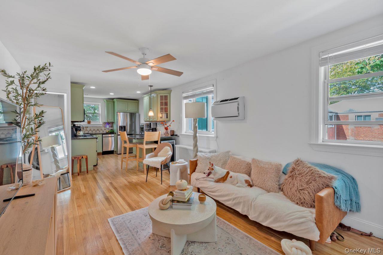 73-20 263rd Street, Unit G Queens, NY 11004 - Photo 4 of 24 a living room with furniture and wooden floor