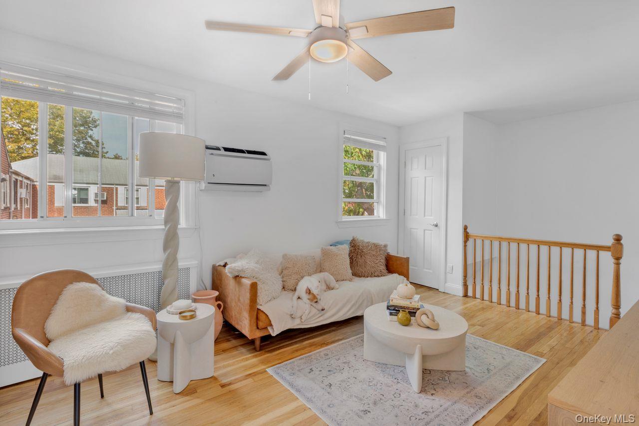 73-20 263rd Street, Unit G Queens, NY 11004 - Photo 5 of 24 a living room with furniture and a window