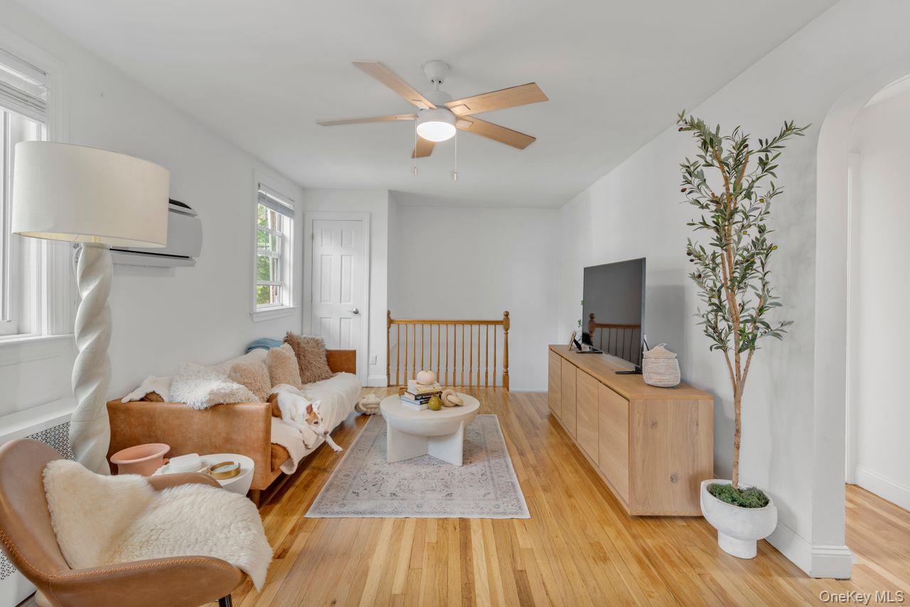 73-20 263rd Street, Unit G Queens, NY 11004 - Photo 6 of 24 a living room with furniture and a flat screen tv