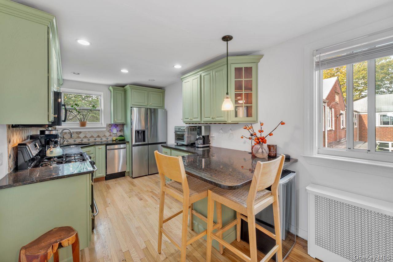 73-20 263rd Street, Unit G Queens, NY 11004 - Photo 8 of 24 a kitchen with a dining table chairs and window