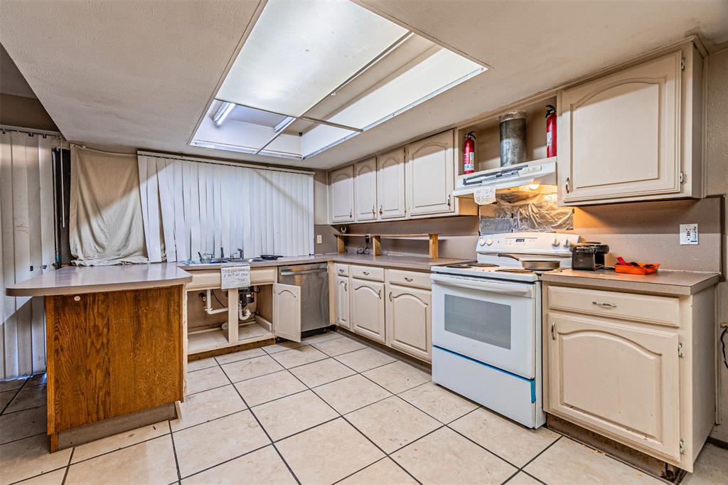 10315 Red Elm Road Dallas, TX 75243 - Photo 12 of 34 a kitchen with a sink window and cabinets