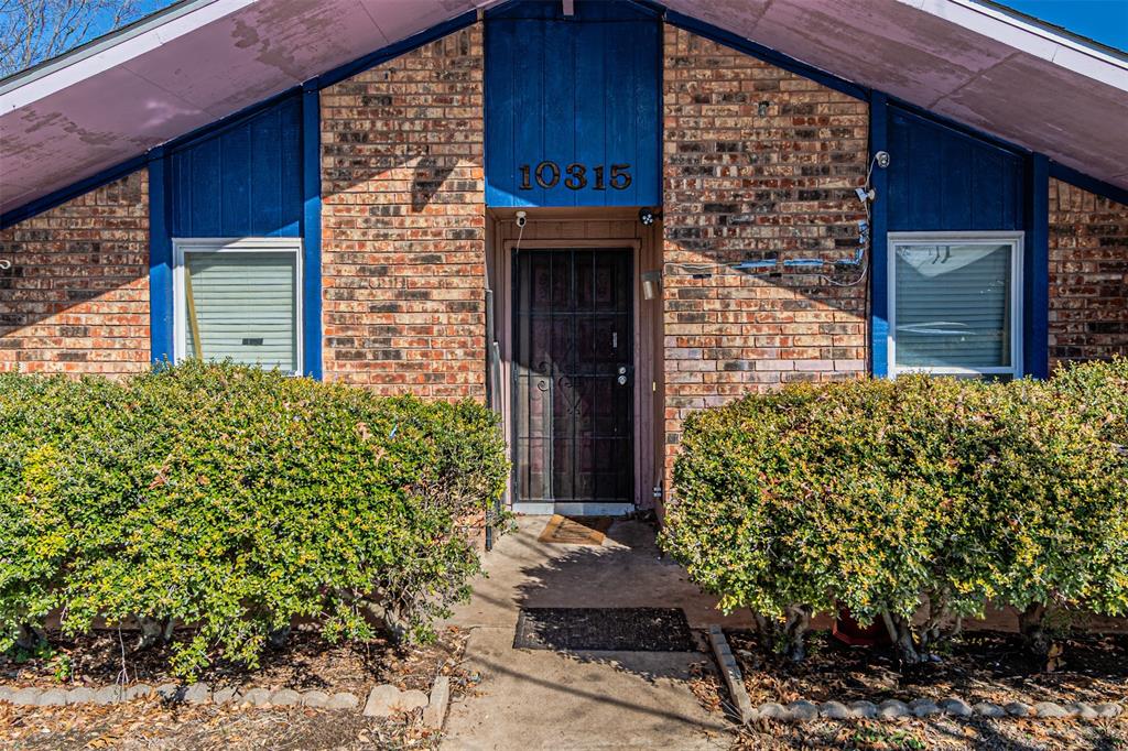 10315 Red Elm Road Dallas, TX 75243 - Photo 4 of 34 a couple of potted plants in front of door