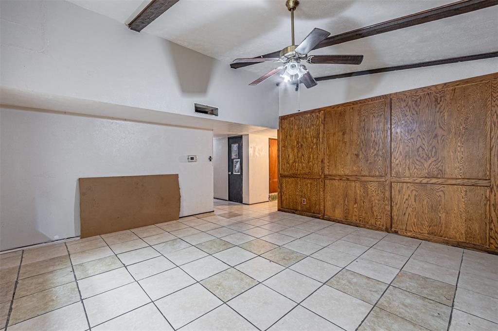 10315 Red Elm Road Dallas, TX 75243 - Photo 9 of 34 a view of a livingroom with an empty space and a ceiling fan