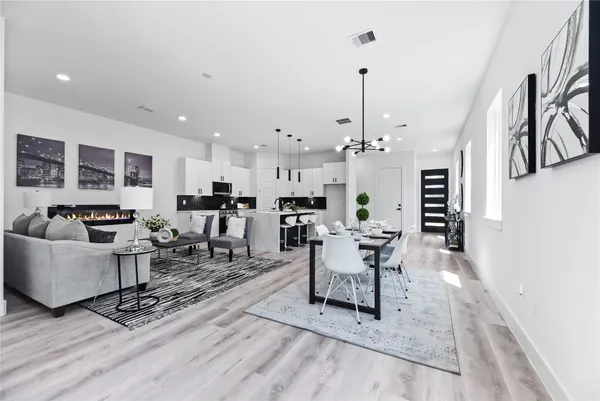 a living room with furniture and kitchen view
