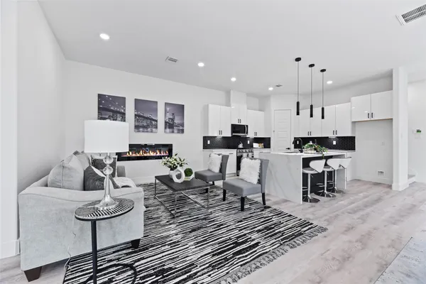 a living room with furniture and kitchen view