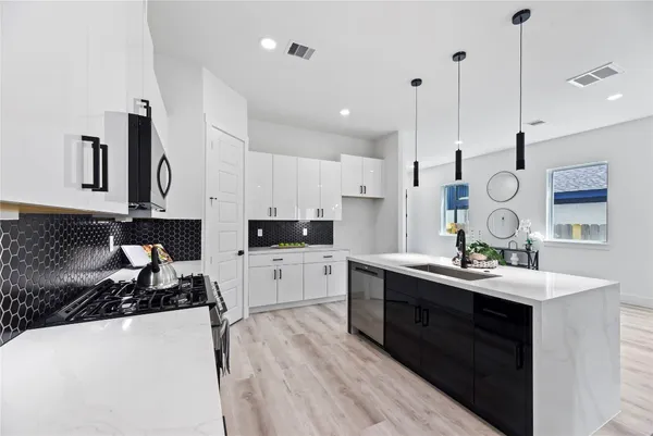 a kitchen with a sink stove and refrigerator