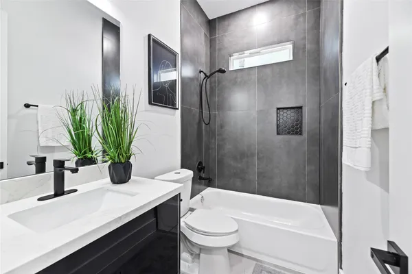 a bathroom with a sink a toilet and tub