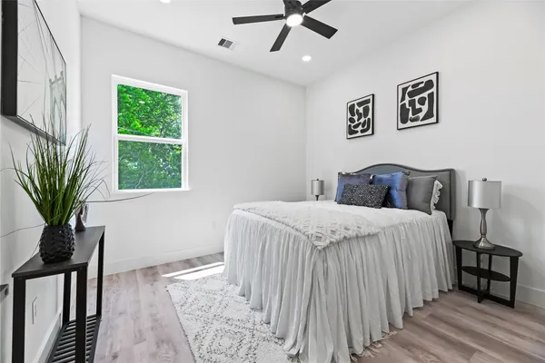 a bedroom with a large bed and a window