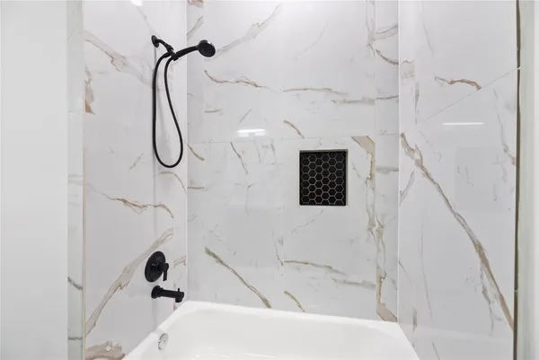 a bathroom with a shower and a shower