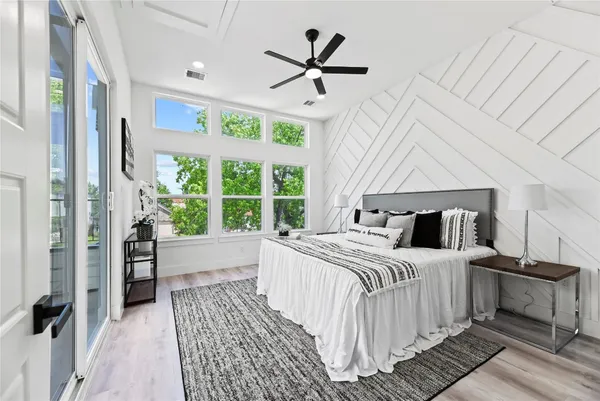 a bedroom with a large bed and a window