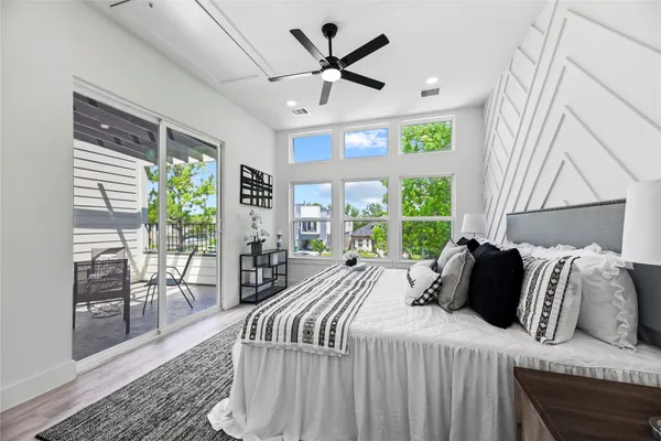a bedroom with a large bed and a large window