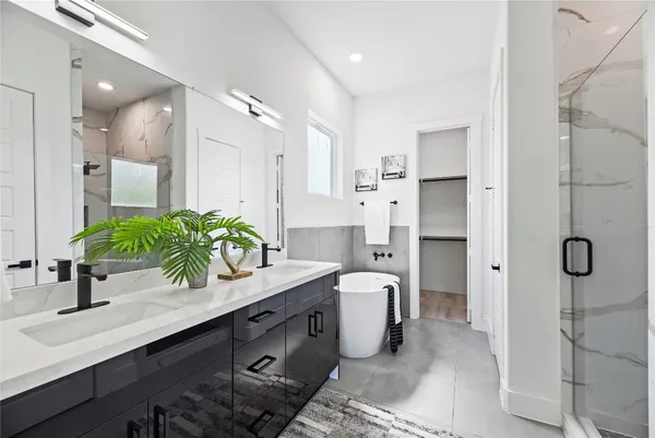 a bathroom with a double vanity sink mirror and shower