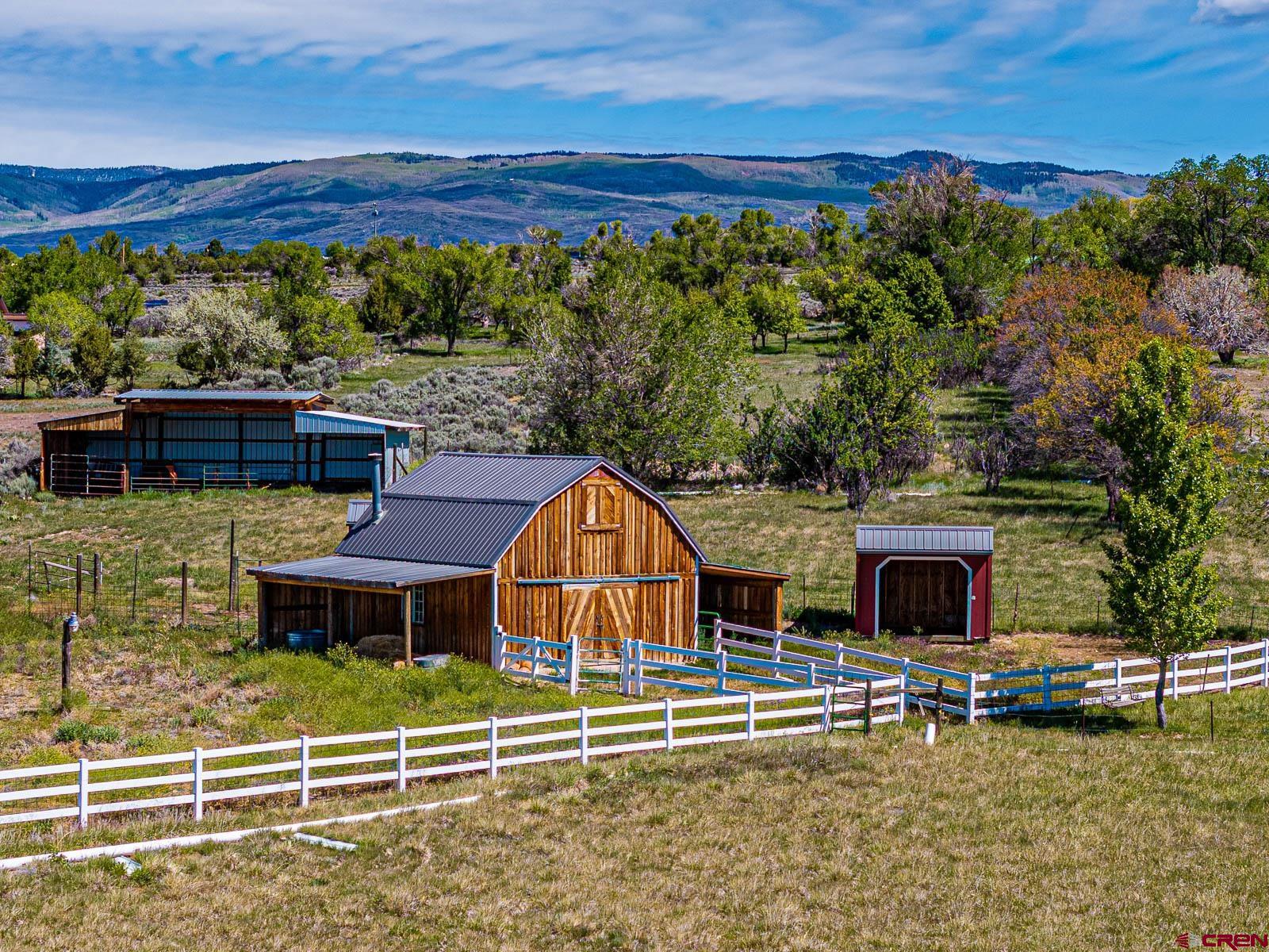 16331 2550th Road Cedaredge, CO 81413 - Photo 39 of 45 a view of a house with wooden deck and a yard